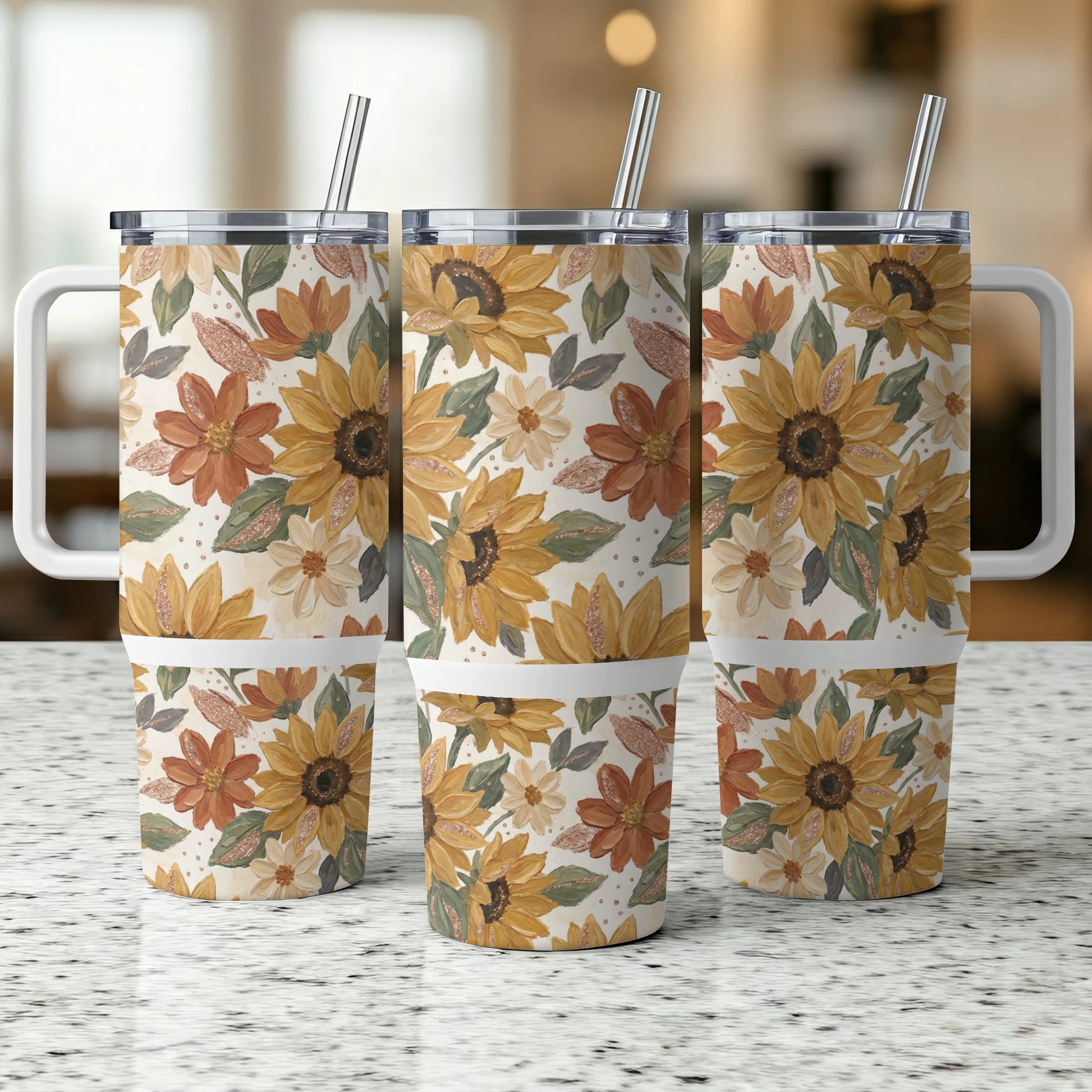 Three travel tumblers with a sunflower and leaf pattern.