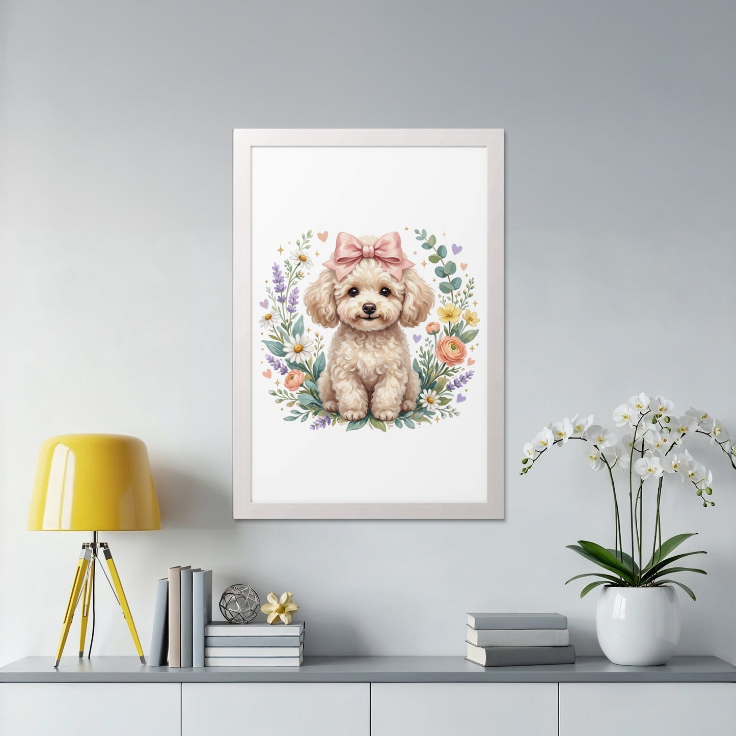 Framed artwork of a cute poodle with a pink bow and floral wreath.