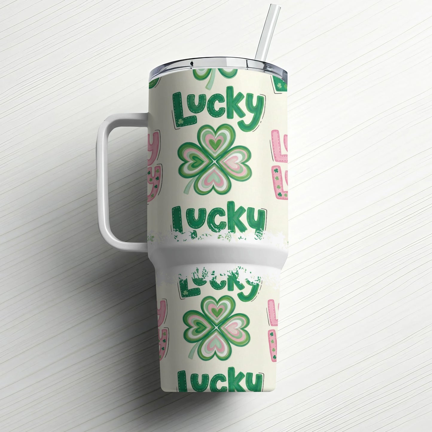 Green lucky clover pattern on insulated tumbler with handle and straw.