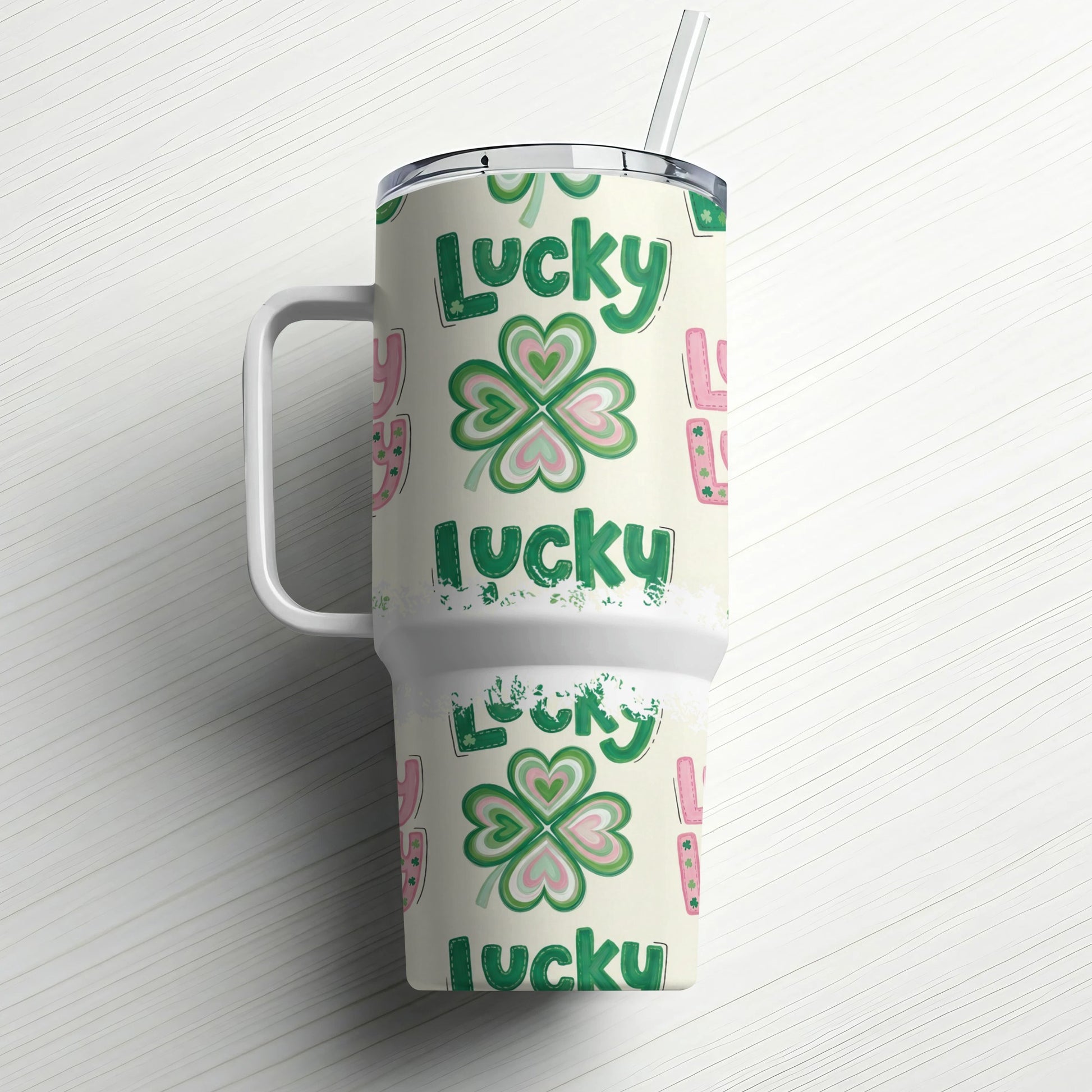 Green lucky clover pattern on insulated tumbler with handle and straw.