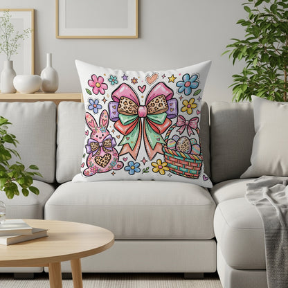 Easter pillow with a pink bunny, basket of eggs, and flowers.