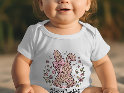 Baby wearing white onesie with leopard print bunny and "Happy Easter" text.