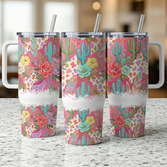 Three tumblers with a colorful floral and cactus pattern and white handles.