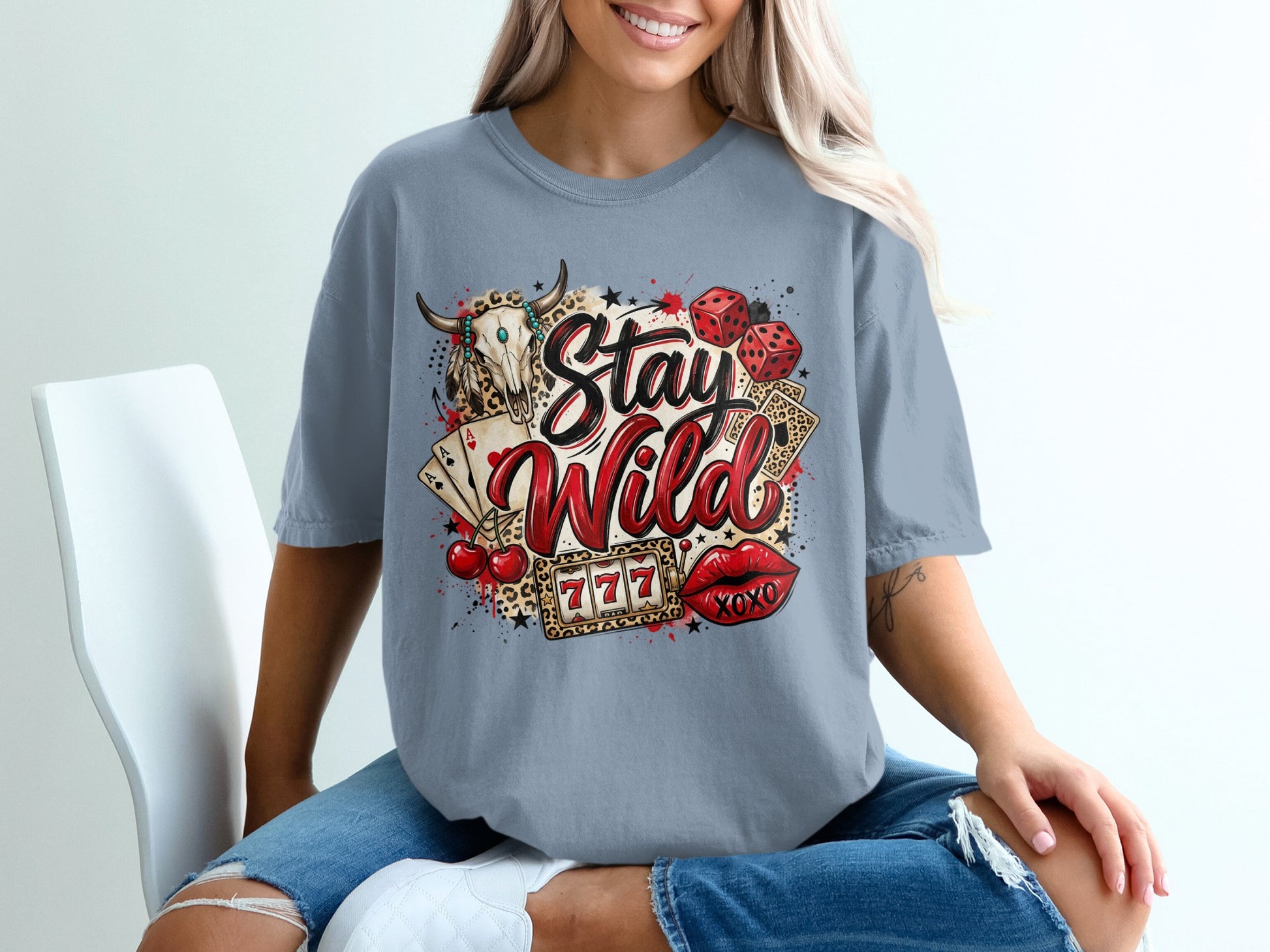 T-shirt with "Stay Wild" text, skull, dice, cherries, lips, and cards.