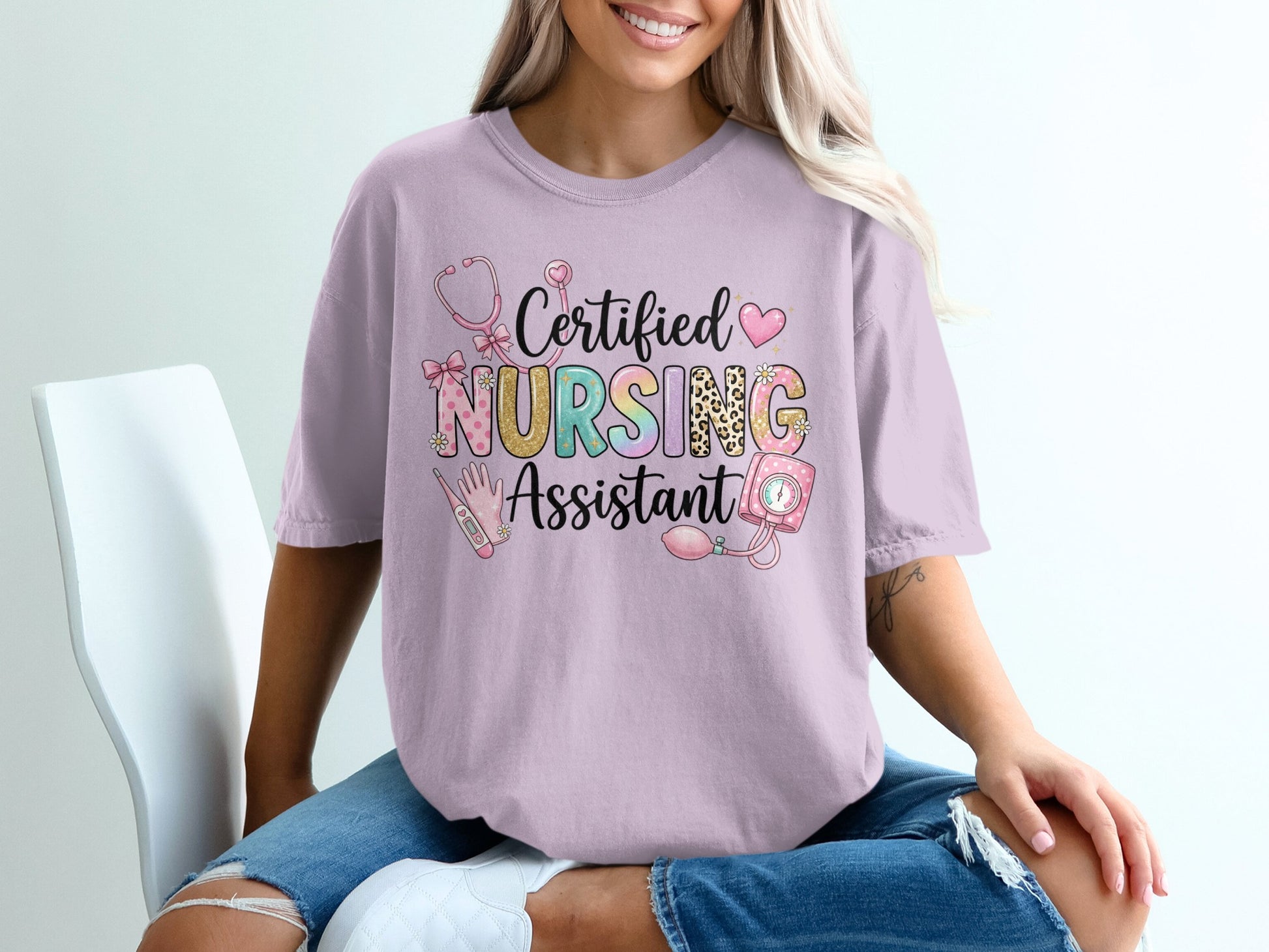 Pink t-shirt with "Certified Nursing Assistant" text and nursing graphics.