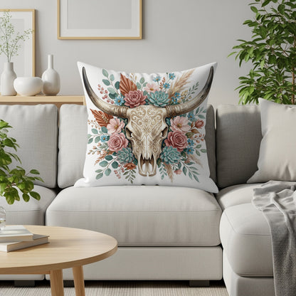 Boho cow skull pillow with floral and succulent accents on a sofa.