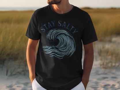 Black t-shirt with "STAY SALTY" text above a blue ocean wave graphic.