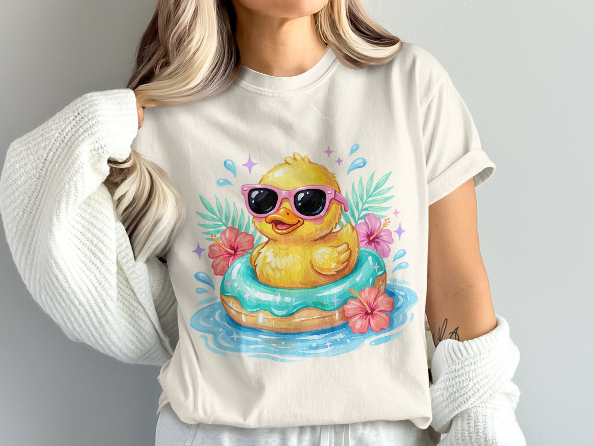 Rubber duck in sunglasses floating on inner tube with hibiscus flowers.