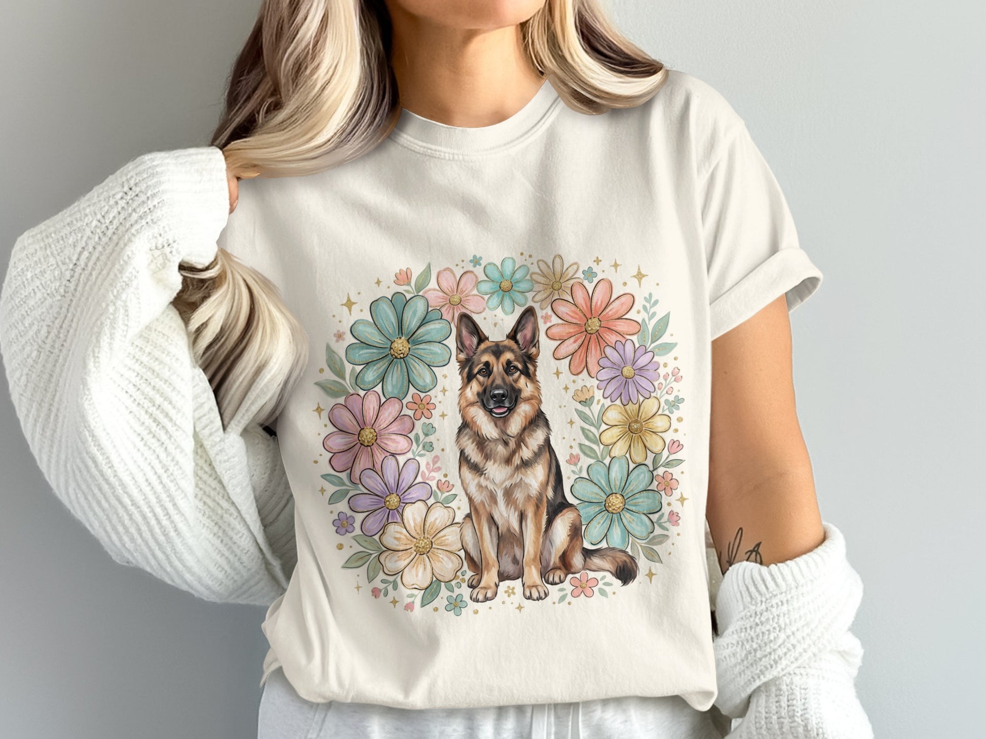 German Shepherd dog surrounded by a pastel floral wreath on a cream t-shirt.