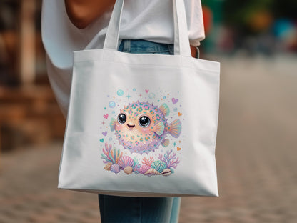 White tote bag with a smiling pufferfish design and coral.