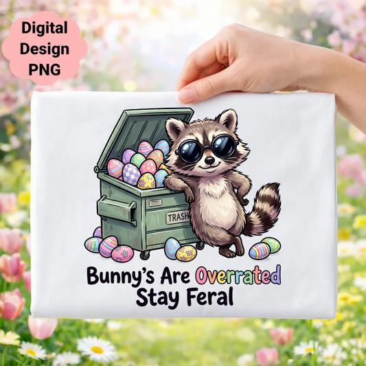 Raccoon wearing sunglasses next to trash can filled with Easter eggs, "Bunny's Are Overrated Stay Feral" text.