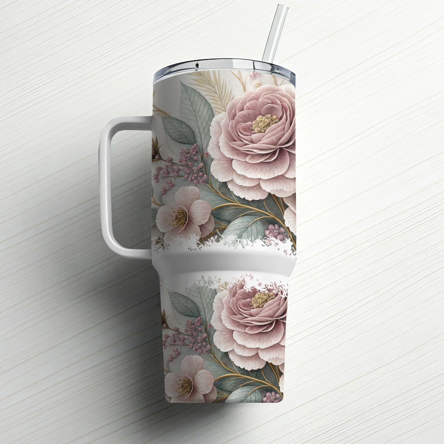 Floral patterned tumbler with handle and straw on a white background.