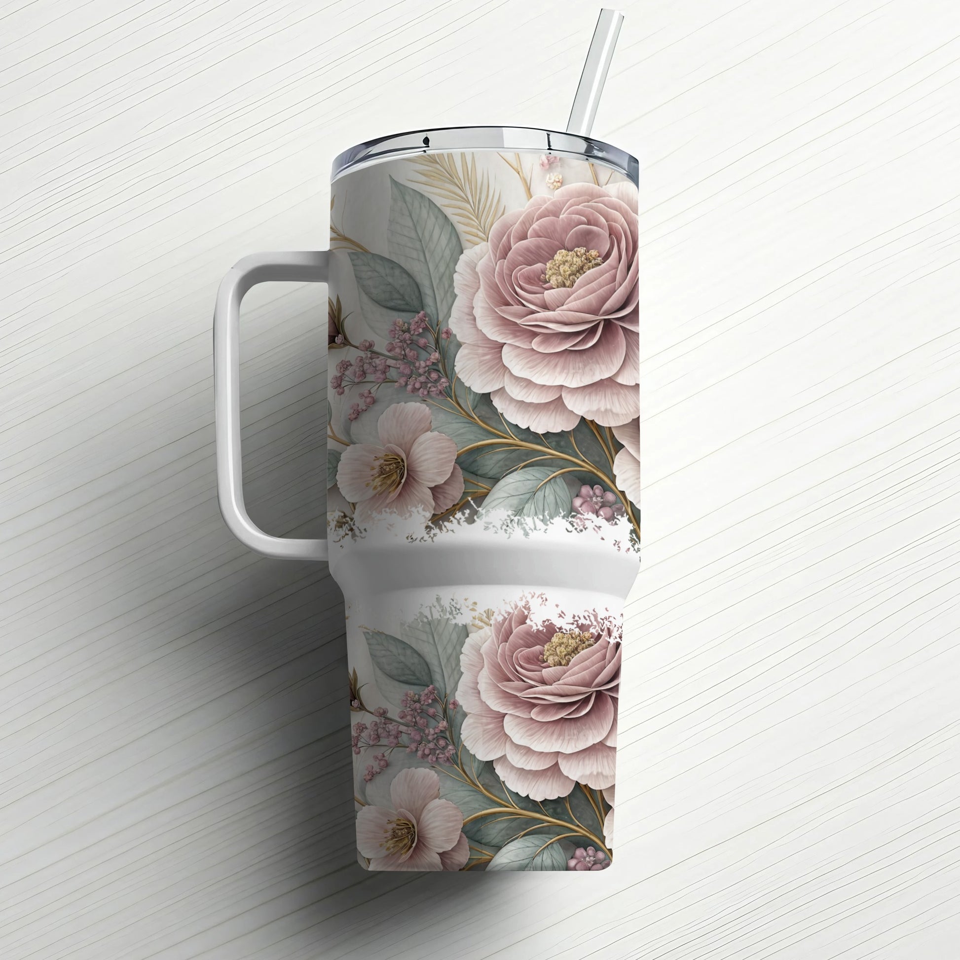 Floral patterned tumbler with handle and straw on a white background.