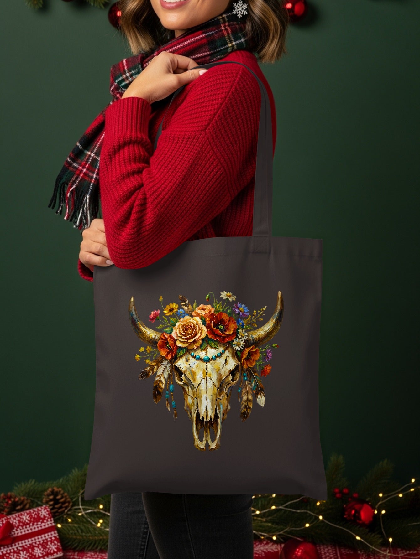 Tote bag featuring a western-style bull skull adorned with flowers and feathers.