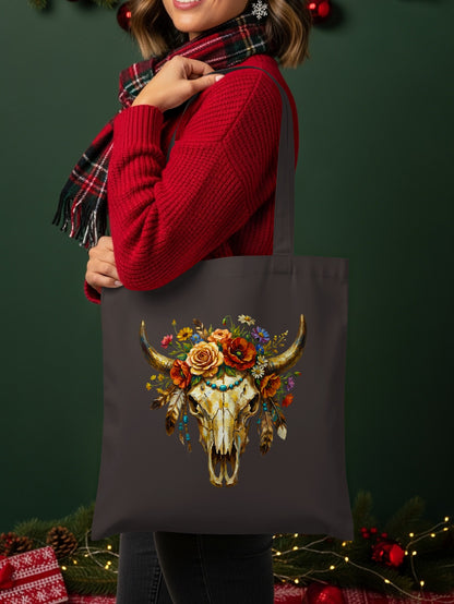 Tote bag featuring a western-style bull skull adorned with flowers and feathers.