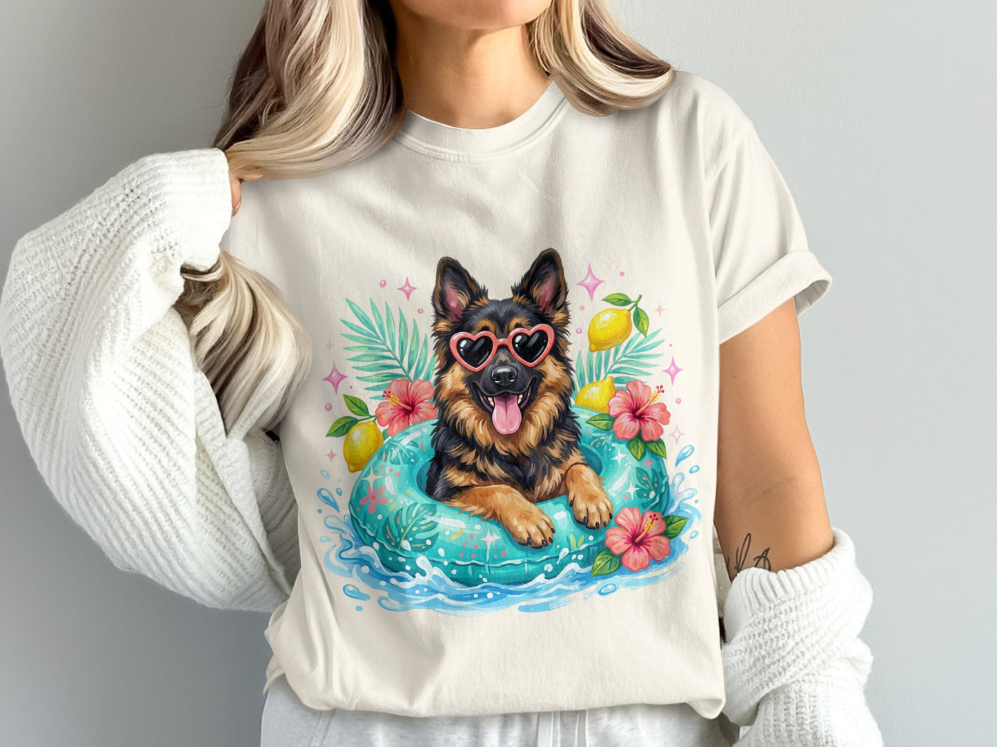 German Shepherd wearing heart sunglasses floats in a pool with hibiscus flowers.