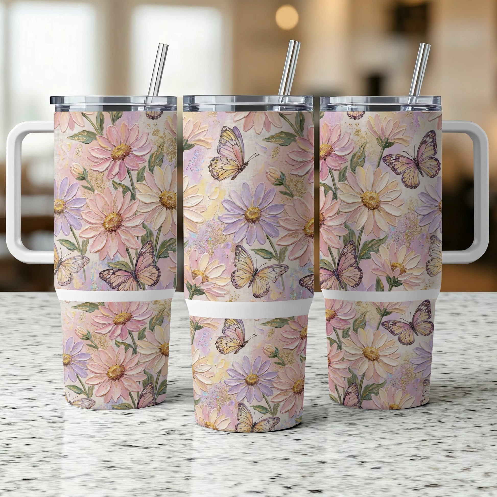 Three travel tumblers with floral and butterfly pattern, with straws.