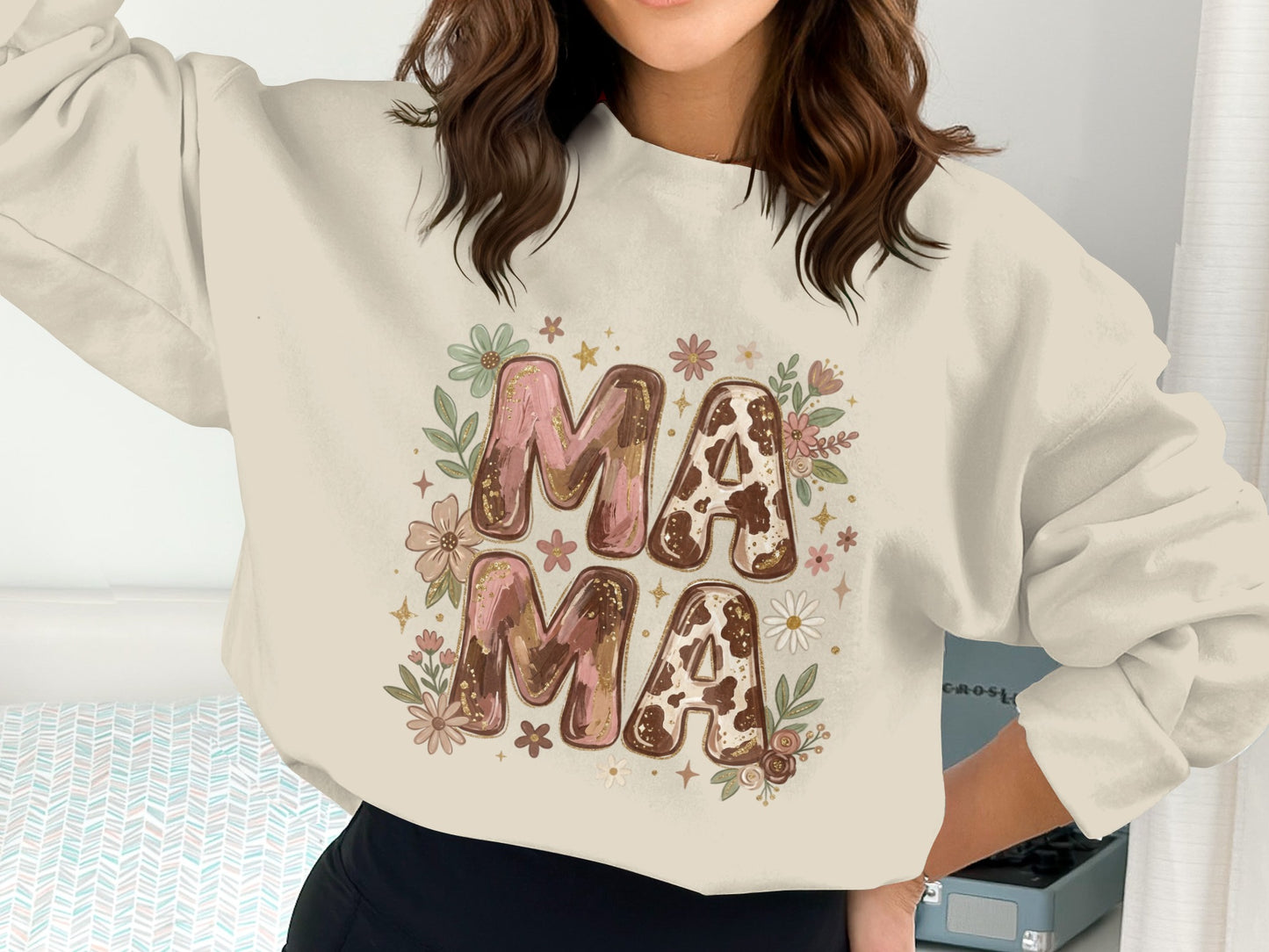 Cream crewneck sweatshirt with "Mama Mama" in cow print and floral graphics.