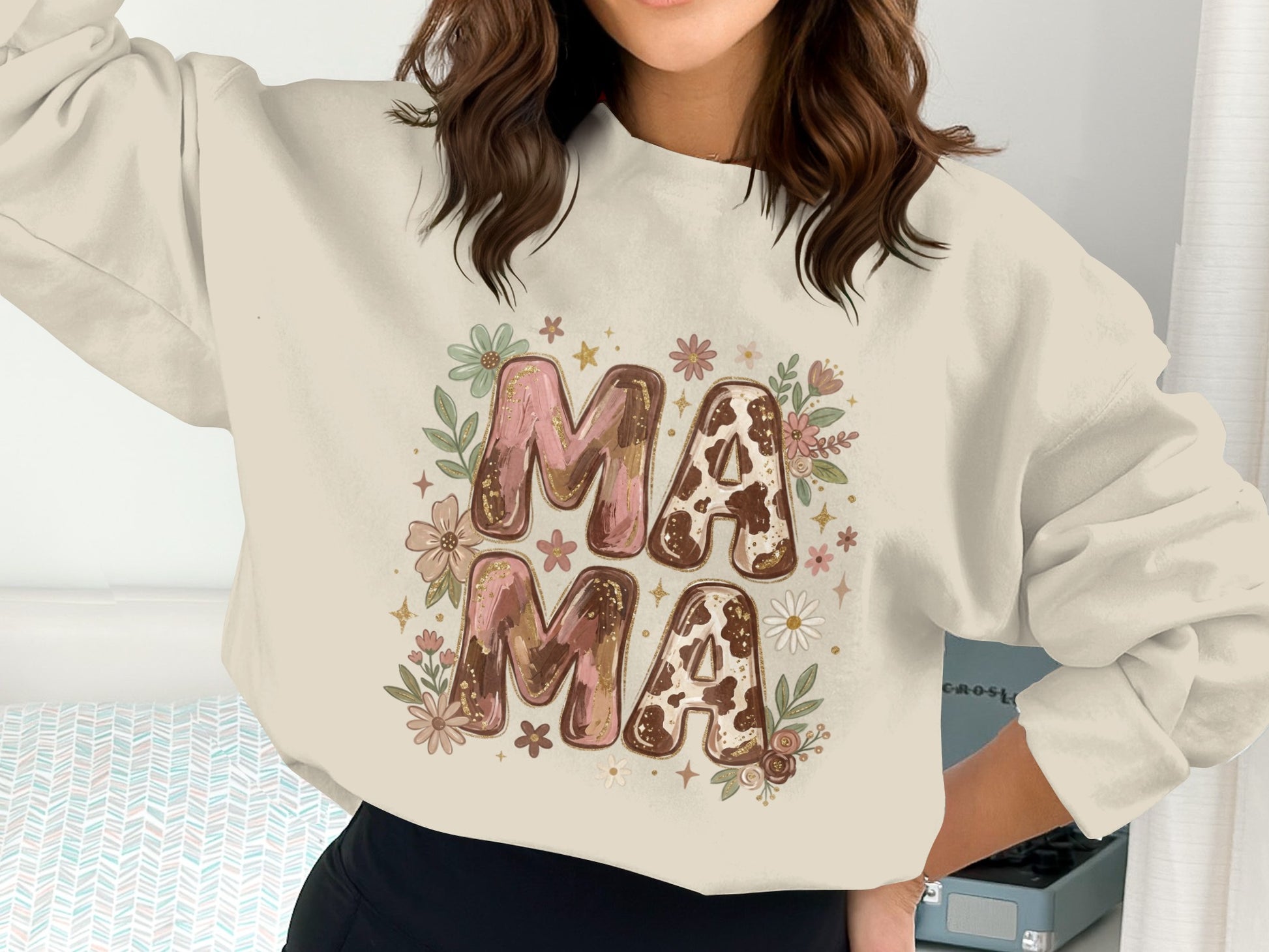 Cream crewneck sweatshirt with "Mama Mama" in cow print and floral graphics.
