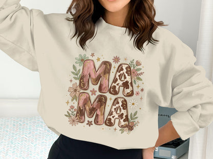 Cream crewneck sweatshirt with "Mama Mama" in cow print and floral graphics.