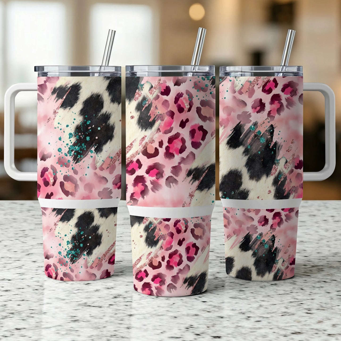 Three insulated tumblers with leopard print, cow print, and pink glitter patterns.