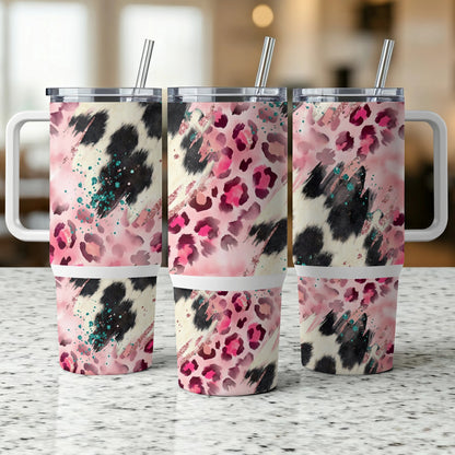 Three insulated tumblers with leopard print, cow print, and pink glitter patterns.