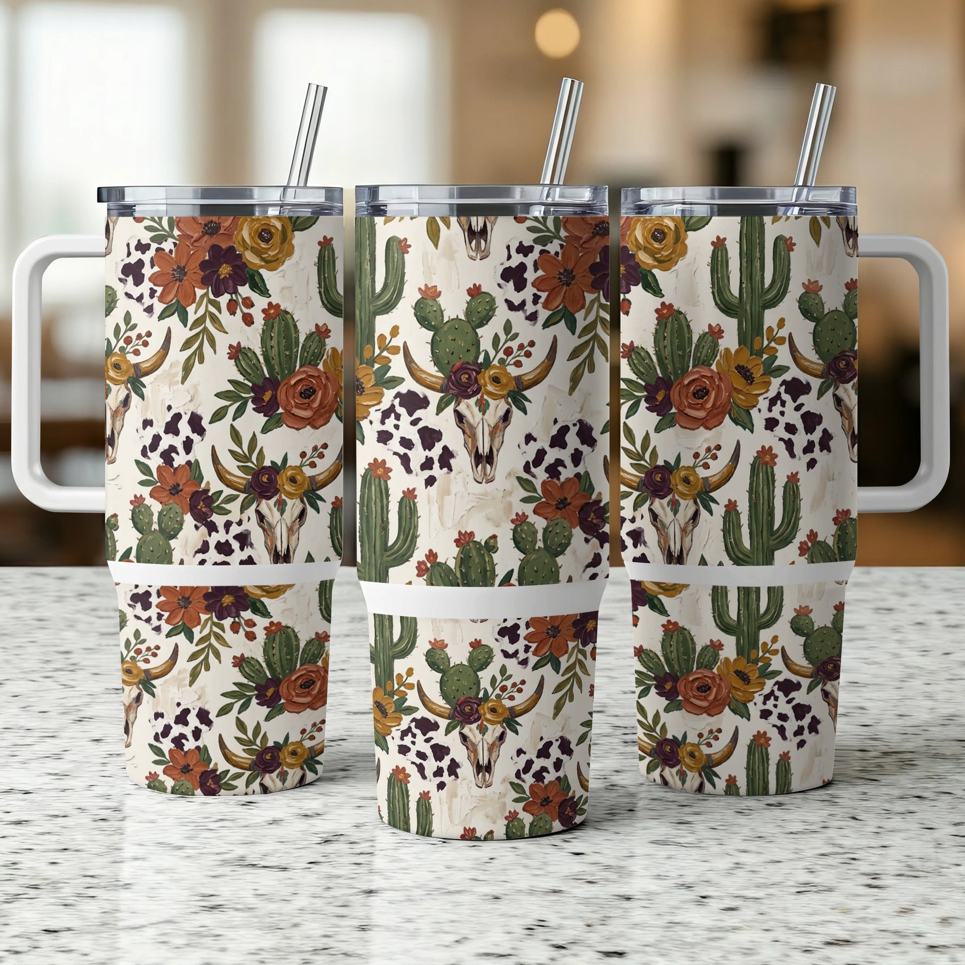 Three tumblers with a cow skull, cactus, and floral pattern.