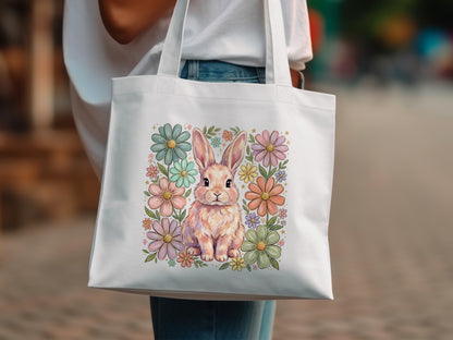 White tote bag with a pastel bunny surrounded by floral art.