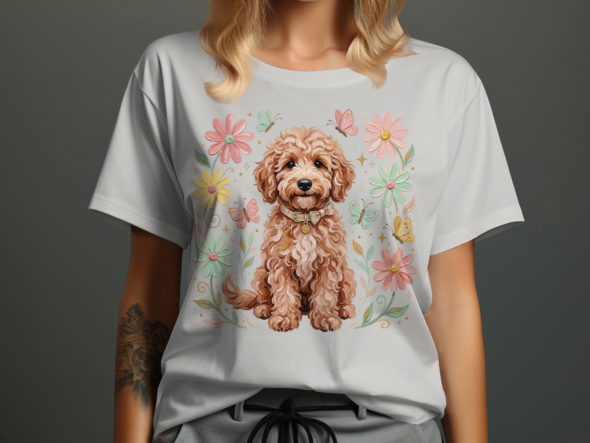 White t-shirt with a seated fluffy dog surrounded by pastel flowers and butterflies.