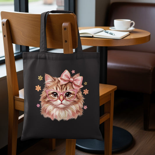 Black tote bag featuring a fluffy cat illustration with pink glasses and bow.