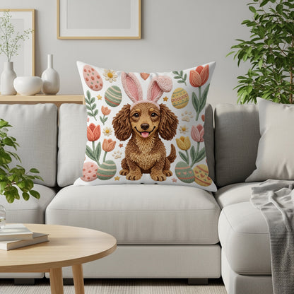 Dachshund wearing bunny ears on a pillow with Easter eggs and tulips.