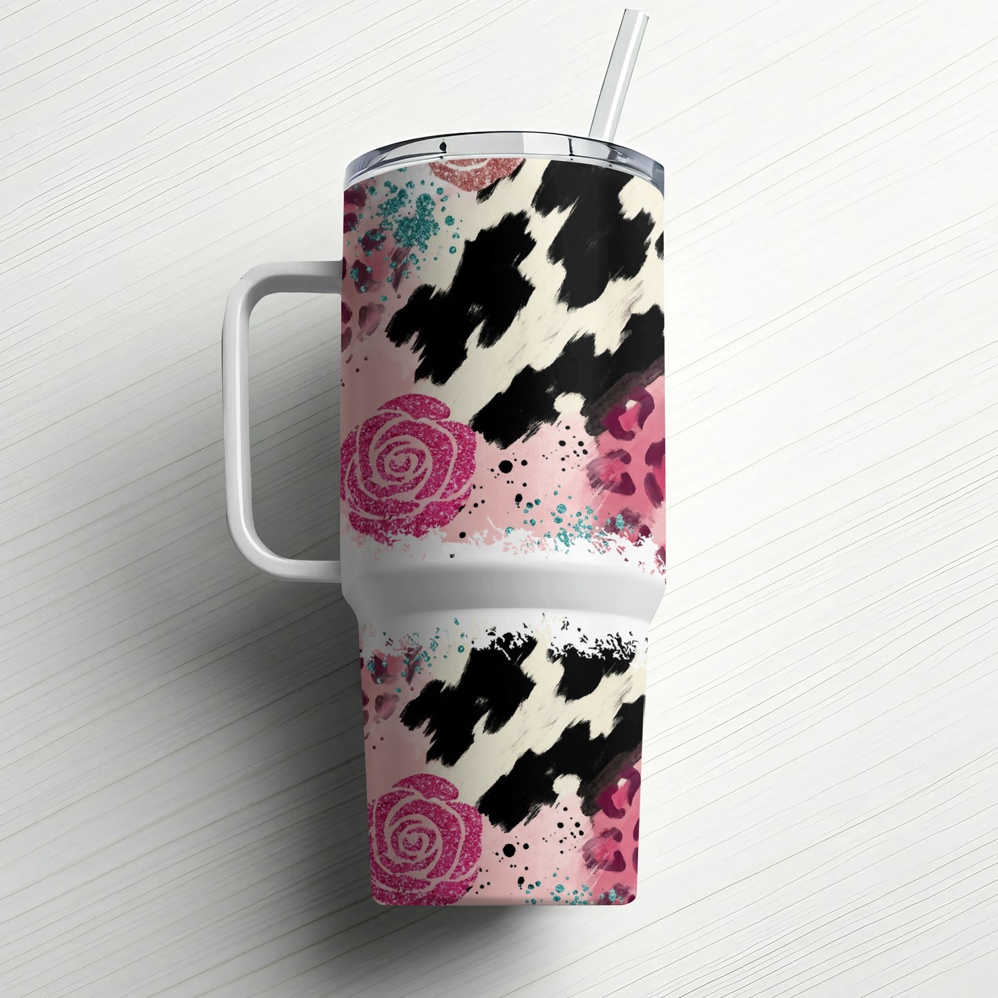 White tumbler with cow print, pink roses, and leopard spots.