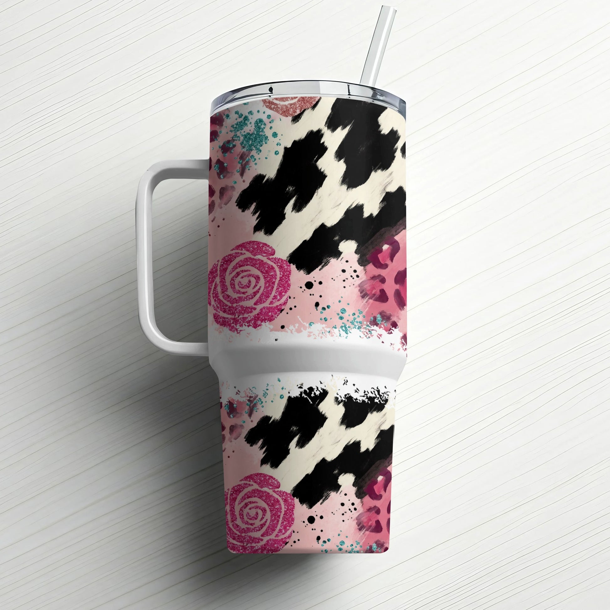 White tumbler with cow print, pink roses, and leopard spots.