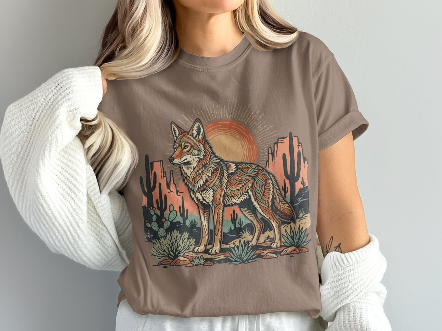 T-shirt with a desert scene featuring a coyote and colorful geometric patterns.