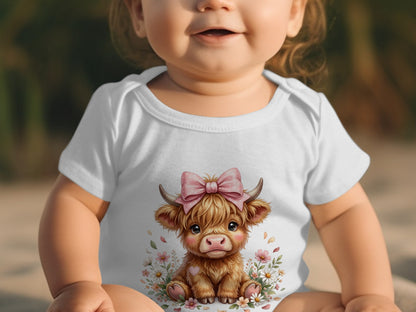 White baby onesie with a cartoon Highland cow wearing a pink bow.