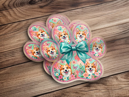 Paw print sticker design with Corgi faces, butterflies, and flowers, tied with a bow.