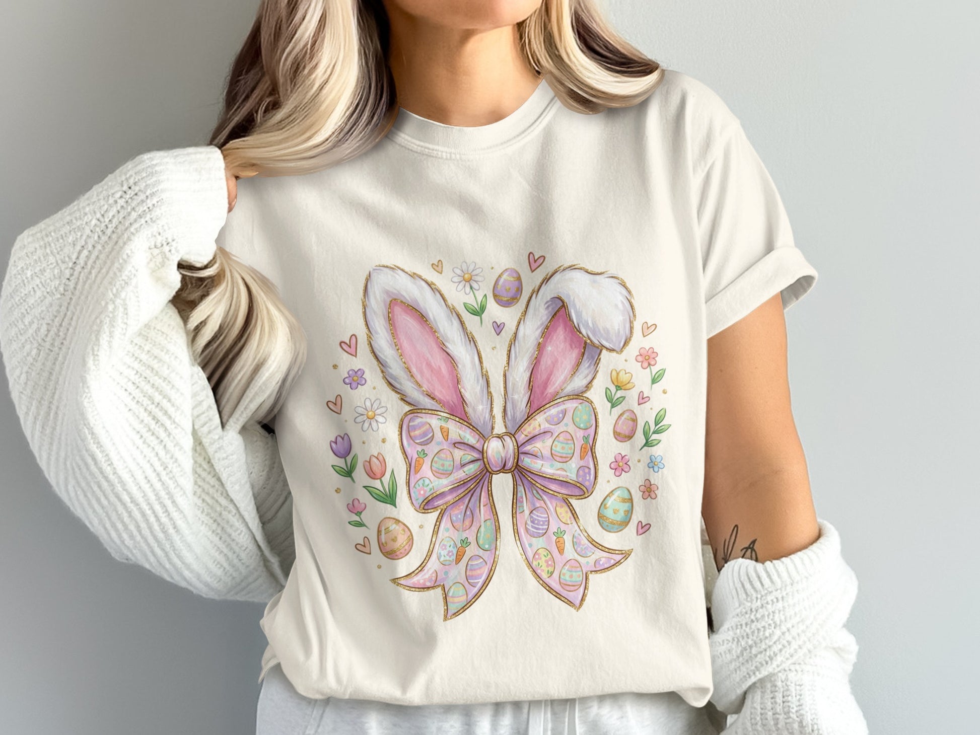 T-shirt with pastel Easter bunny ears and bow graphic.