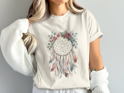 Cream t-shirt featuring a dreamcatcher with feathers and floral accents.