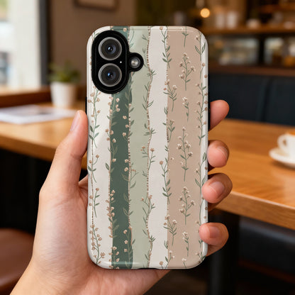Hand holding phone case with vertical floral stripe pattern.
