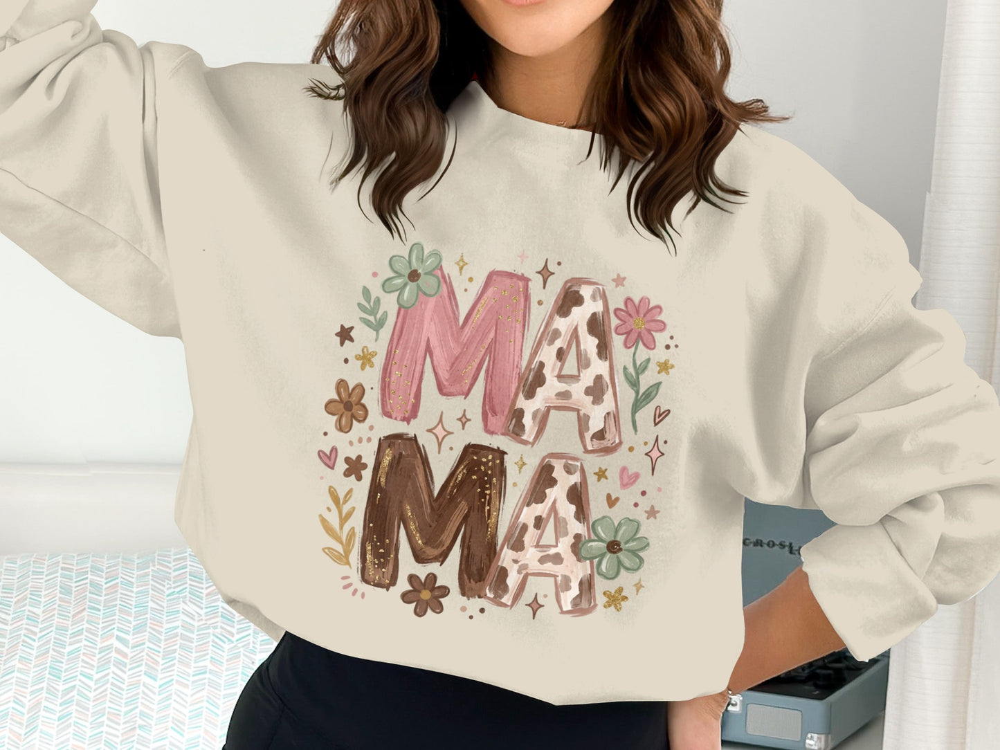 Cream sweatshirt with "Mama" in floral and cow print, surrounded by flowers.