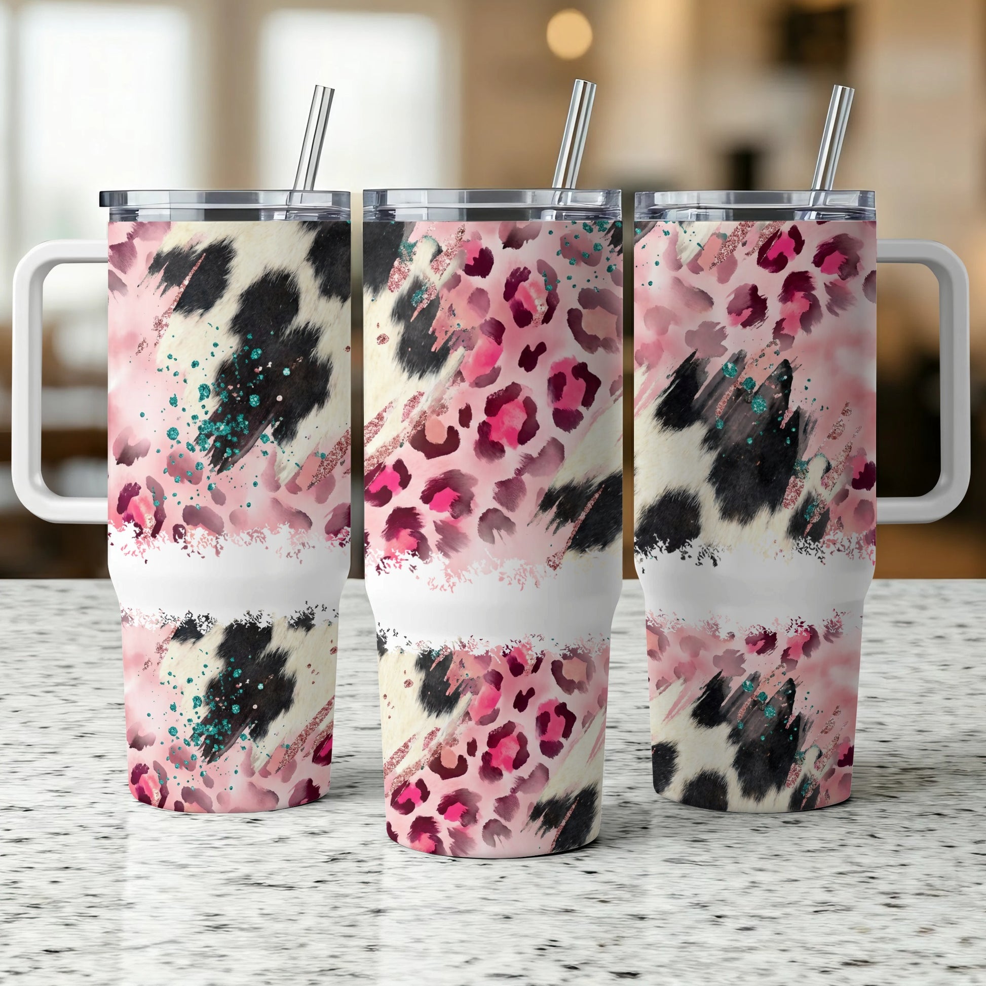 Three tumblers with pink, black, and white cheetah print patterns.