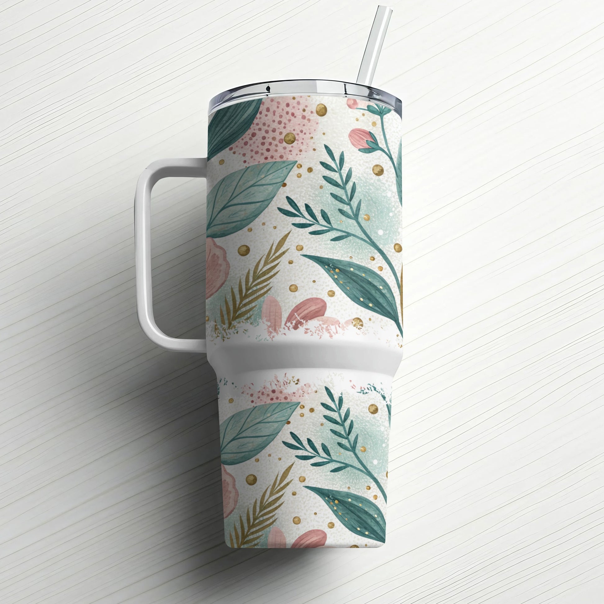 White tumbler with handle and straw, decorated with pink and green floral pattern.