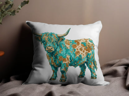 Highland cow with turquoise and gold abstract design on white pillow.