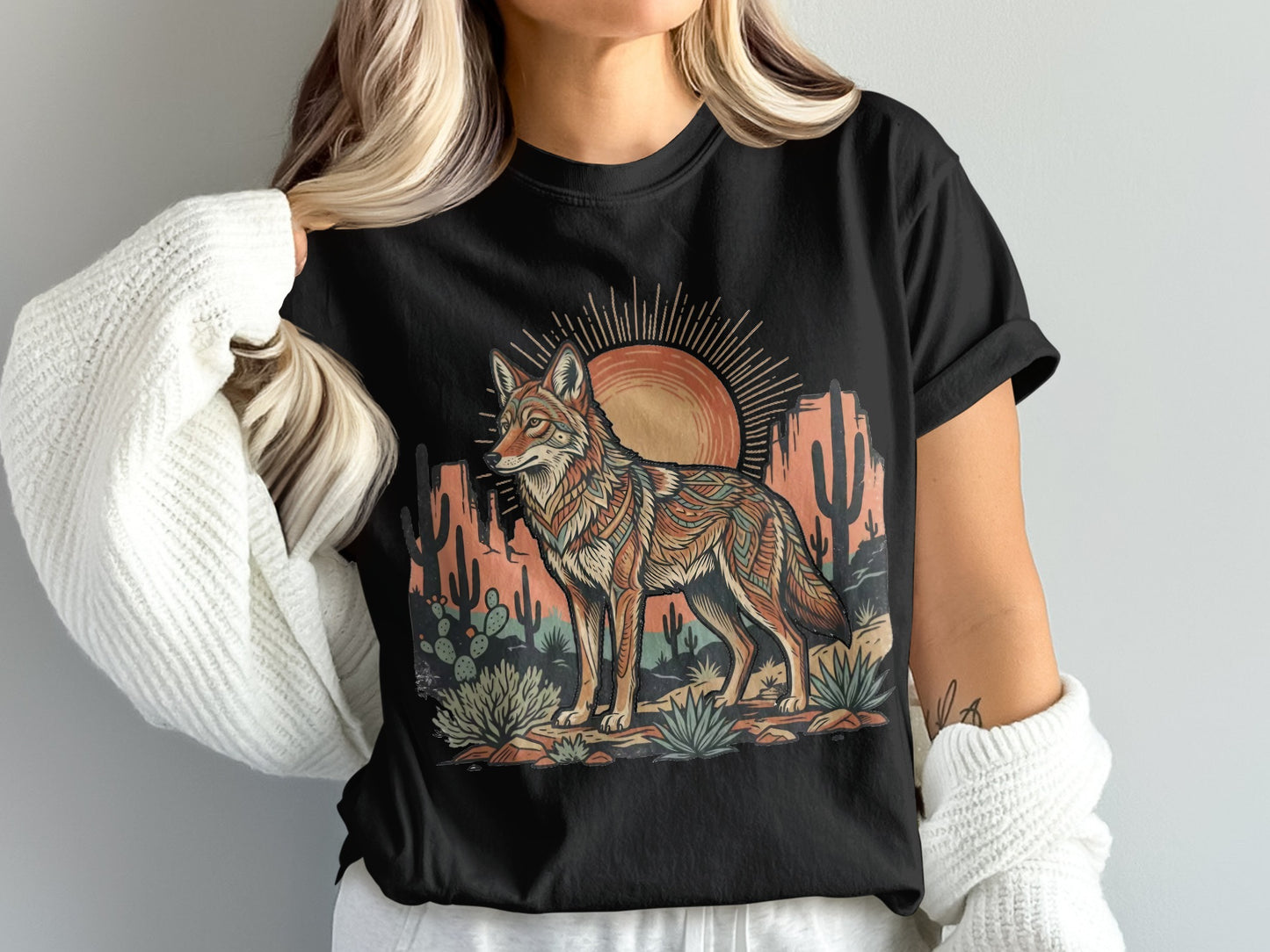 Black t-shirt with a desert coyote illustration and sun graphic.