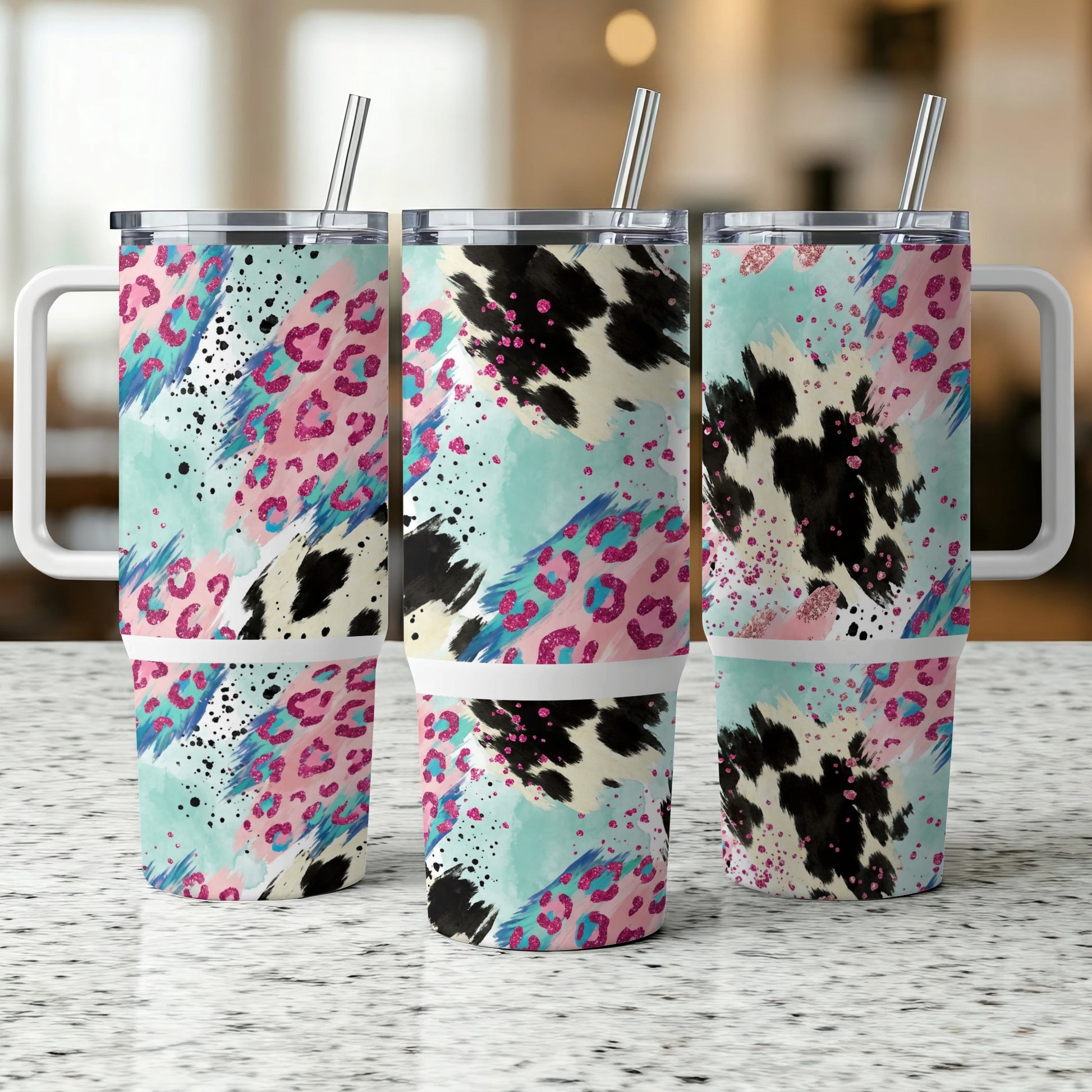 Three tumblers with abstract animal print and pastel color splashes.