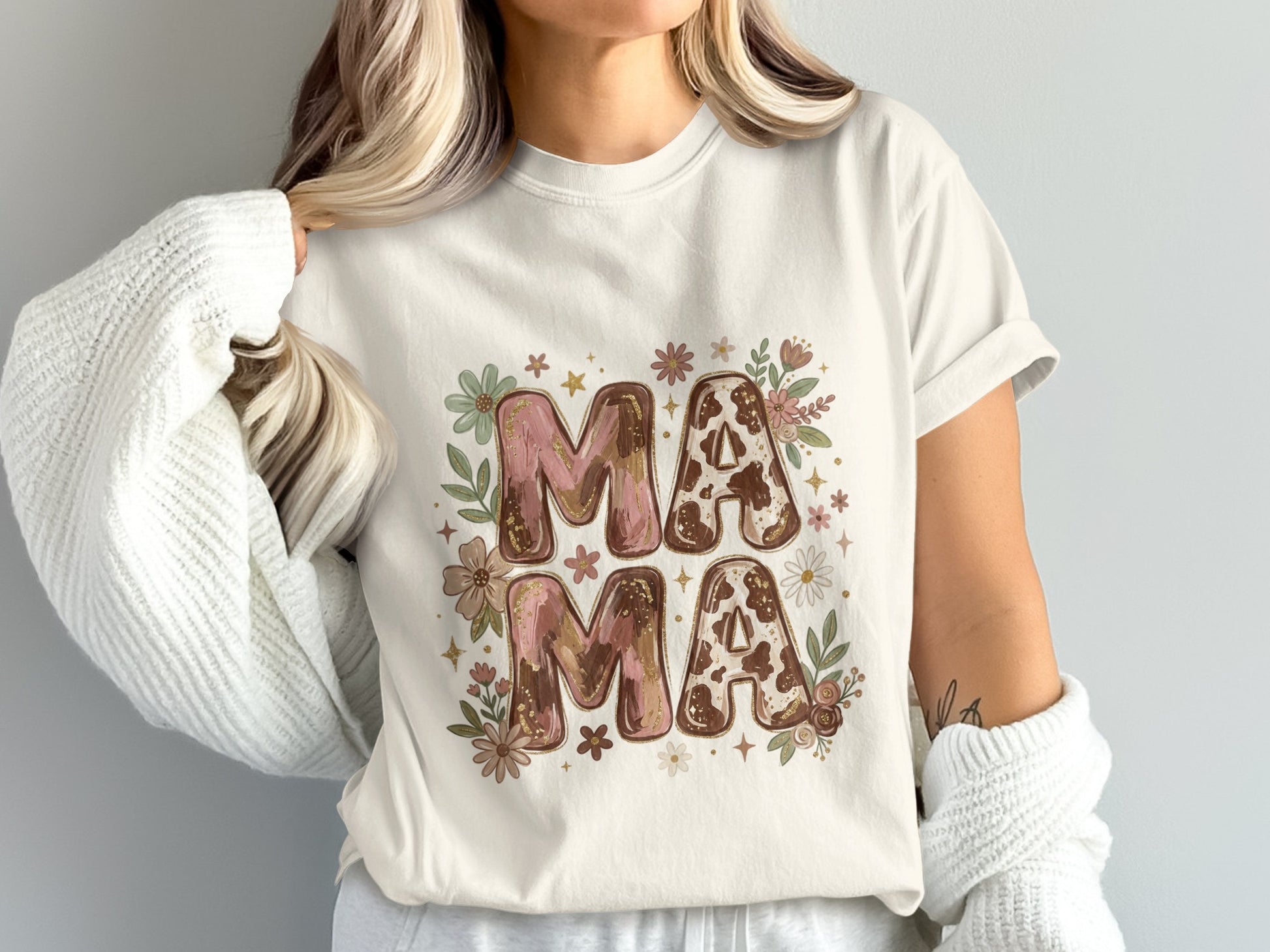 Cream t-shirt with "MAMA" in cow print and floral letters.