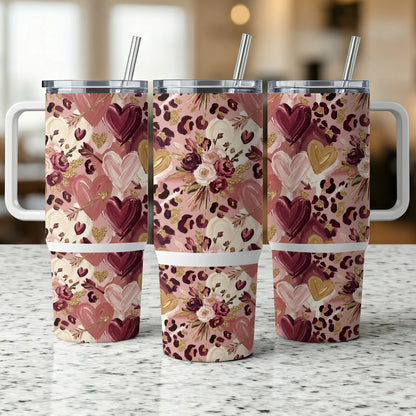 Three tumblers with leopard print, hearts, and floral designs.