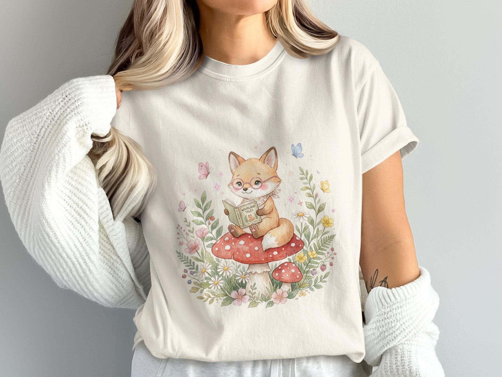 Fox reading a book on a mushroom surrounded by flowers.