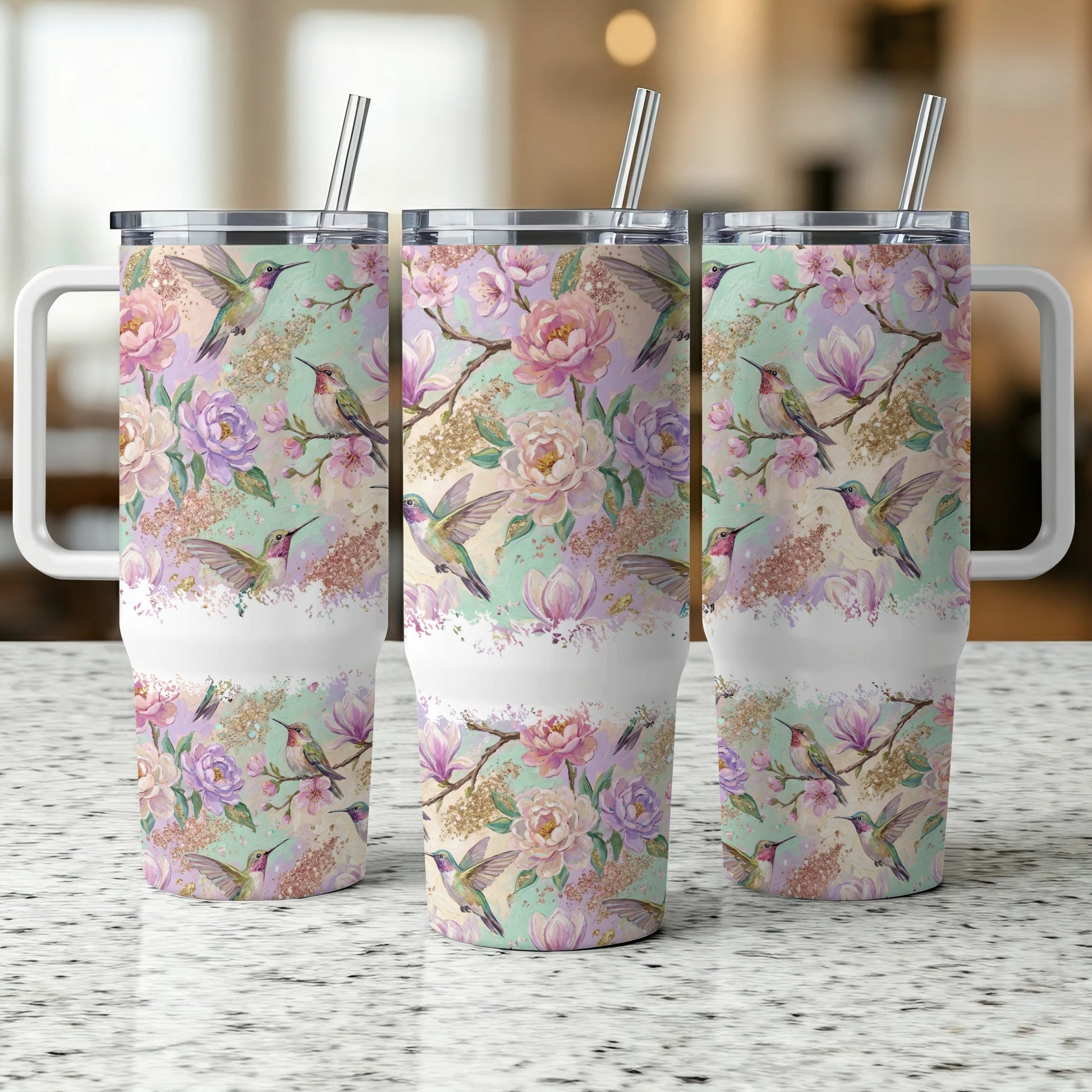 Hummingbirds and floral pattern on three white insulated tumblers.