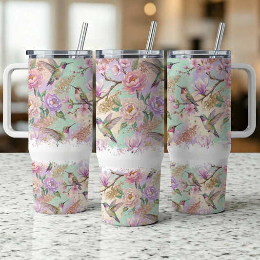 Hummingbirds and floral pattern on three white insulated tumblers.